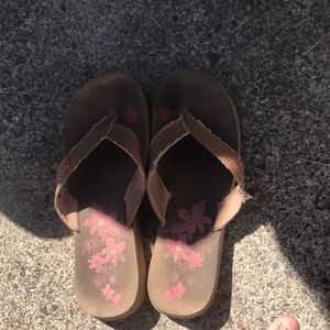 Brown Nike flip flops